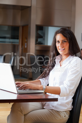 Portrait of a young woman using a laptop