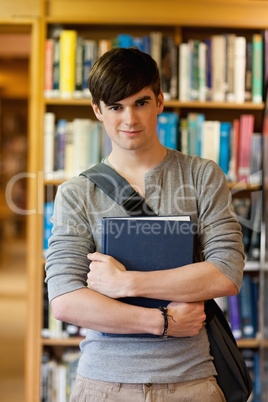Portrait of young student holding a book