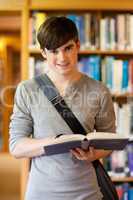 Portrait of a handsome student holding a book