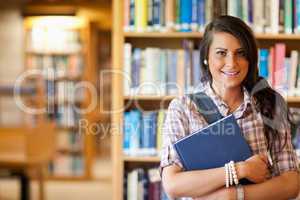 Portrait of a student posing with a book