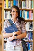 Portrait of a cute student posing with a book