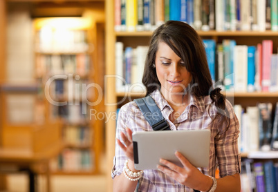 Cute young student using a tablet computer