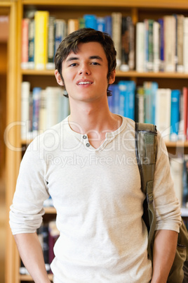 Portrait of a good looking student standing up