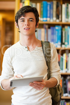 Portrait of a serious student holding a tablet computer