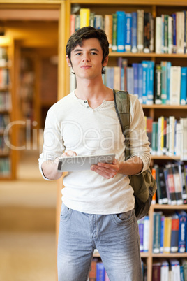Portrait of a smiling student holding a tablet computer