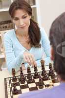 Beautiful Woman Playing Chess With Her Husband