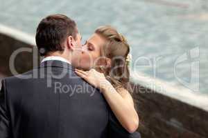 young wedding couple kissing