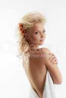 Beauty naked woman with flower in blond hair