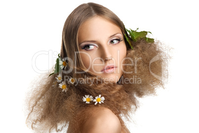 Beauty girl with leaves and camomile in hair