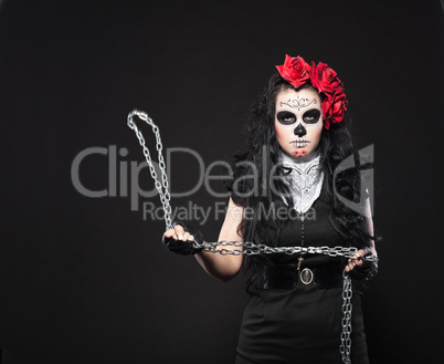 Depressed woman in day of the dead mask with chain