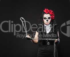 Depressed woman in day of the dead mask with chain