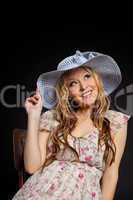 Blond pregnant woman portrait in straw hat