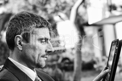 Business Man Working Outdoor with his Tablet