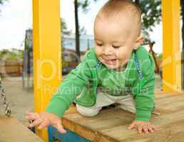 Little boy is playing on playground