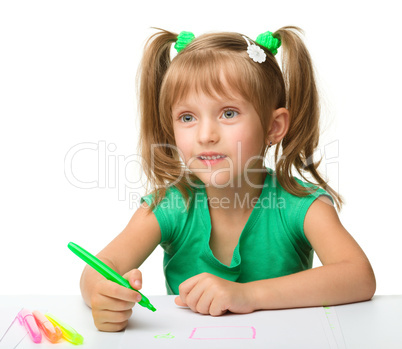 Cute little girl draws with markers