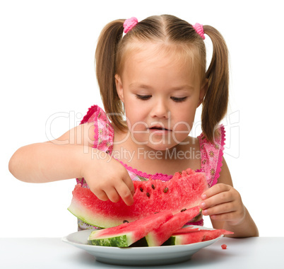 Cute little girl is going to eat watermelon