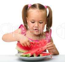 Cute little girl is going to eat watermelon