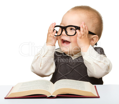 Little child play with book and glasses