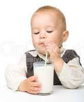 Cute little boy is drinking milk