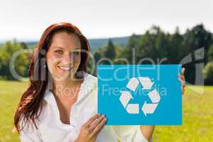 Recycling sign - Young businesswoman sunny meadow