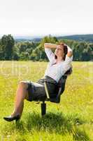 Young businesswoman sunny meadow relax on armchair