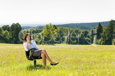 Attractive businesswoman sit armchair sunny meadow