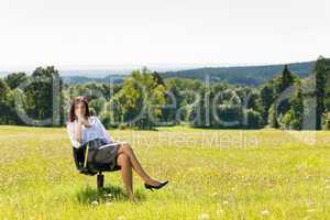 Attractive businesswoman sit armchair sunny meadow