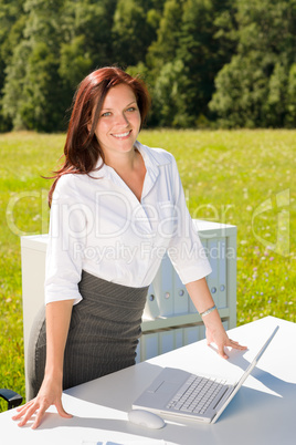 Businesswoman in sunny nature office smile