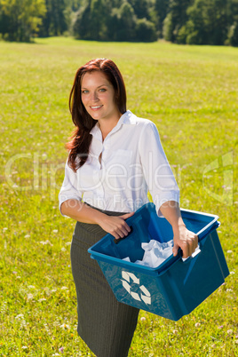 Recycling paper box businesswoman in sunny meadow