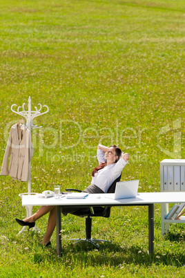 Businesswoman in sunny meadow relax nature office