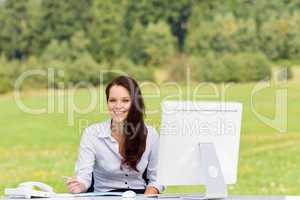 Businesswoman in nature attractive smile computer