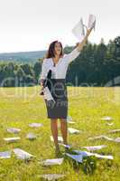 Businesswoman sunny meadow throw papers freedom