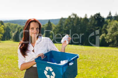 Recycling paper box businesswoman in sunny meadow