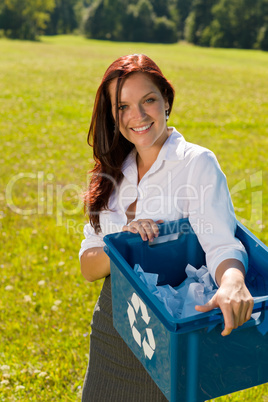 Recycling paper box businesswoman in sunny meadow