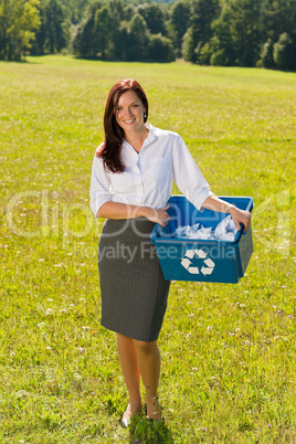 Recycling paper box businesswoman in sunny meadow