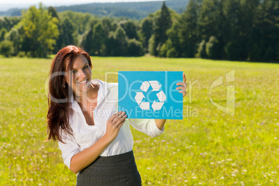 Recycling sign - Young businesswoman sunny meadow