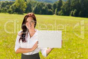 Businesswoman sunny meadow hold empty banner