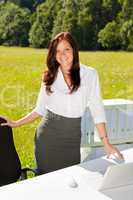 Businesswoman in sunny nature office smile