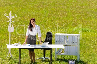 Businesswoman in sunny meadow nature office smile