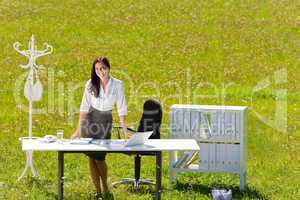 Businesswoman in sunny meadow nature office smile