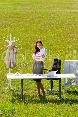 Businesswoman in sunny meadow nature office smile