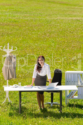 Businesswoman in sunny meadow nature office smile