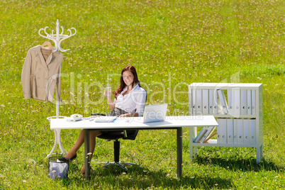 Businesswoman in sunny meadow relax nature office