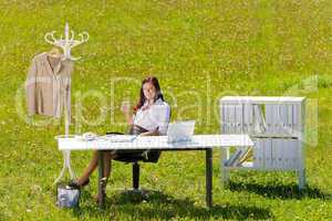Businesswoman in sunny meadow relax nature office
