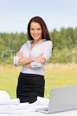 Architect woman in sunny nature smile with laptop