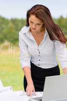 Businesswoman pretty in sunny nature with laptop