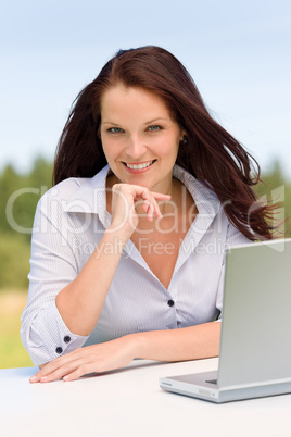 Businesswoman in sunny nature with laptop smile