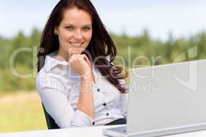 Businesswoman in sunny nature with laptop smile