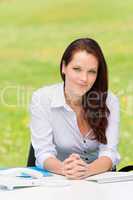 Businesswoman in nature attractive behind table