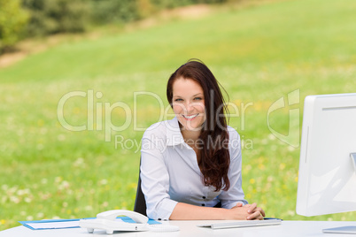 Businesswoman in nature attractive smile computer